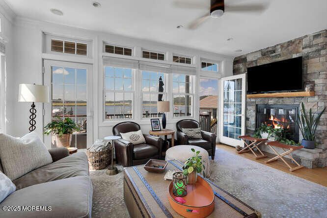 Fireplace, Interior, Living room, Recessed Lighting, Stone Walls, Water, Wood Texture Flooring