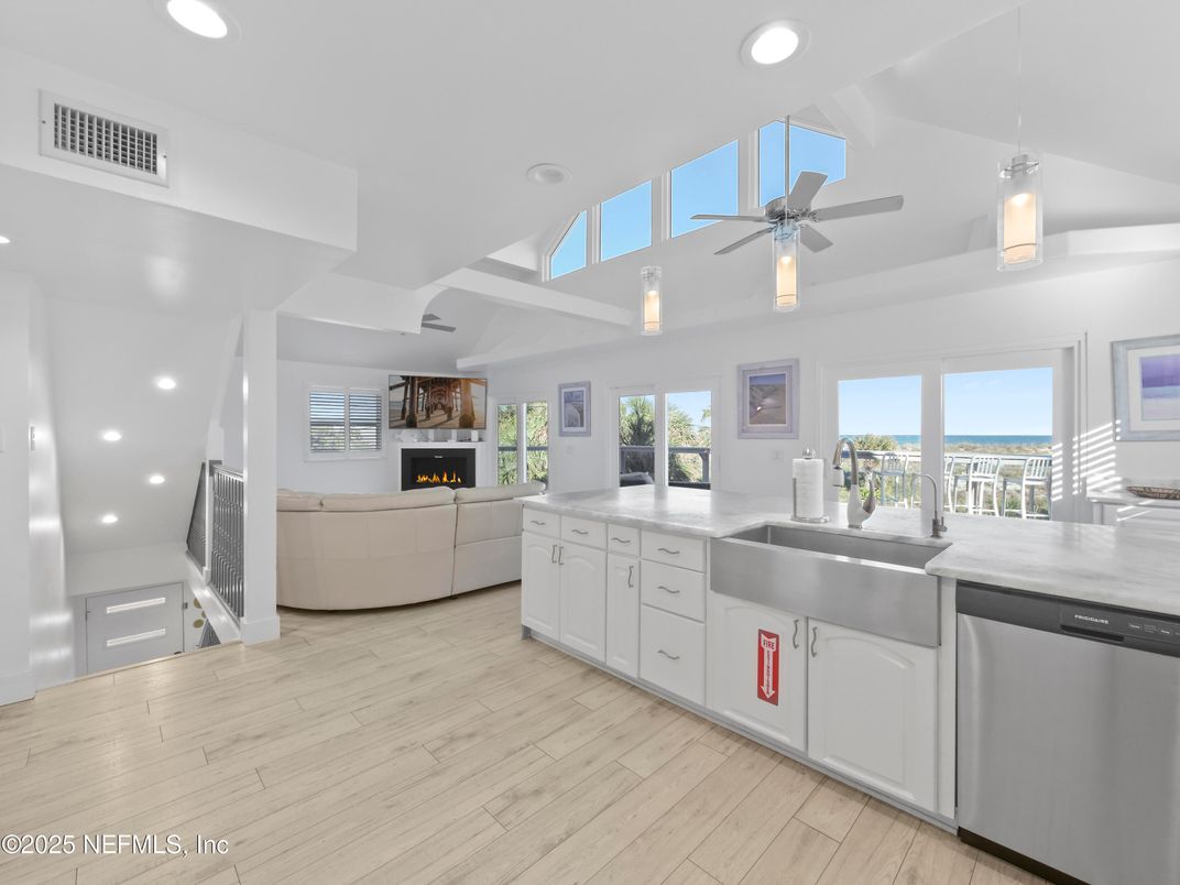 Fireplace, Interior, Kitchen, Living room, Pendant Lights, Recessed Lighting, Stainless Steel Appliances, Water, Wood Texture Flooring