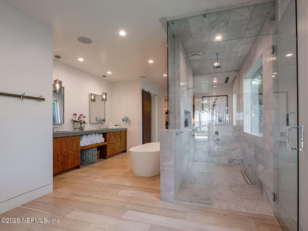 Bathroom, Dual Sink Vanities, Free Standing Baths, Glass Shower, Interior, Marble Walls, Pendant Lights, Recessed Lighting, Wood Texture Flooring