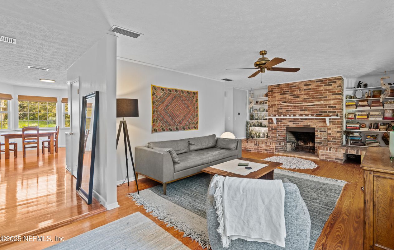 Dining room, Fireplace, Interior, Living room, Recessed Lighting, Stone Walls, Wood Texture Flooring