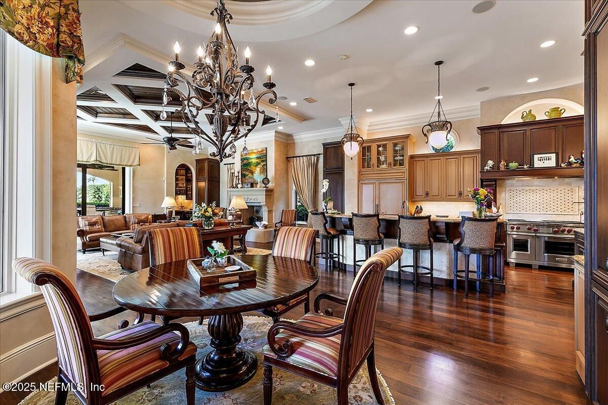 Chandelier, Dining room, Fireplace, Interior, Kitchen, Living room, Pendant Lights, Recessed Lighting, Stainless Steel Appliances, Wood Texture Flooring