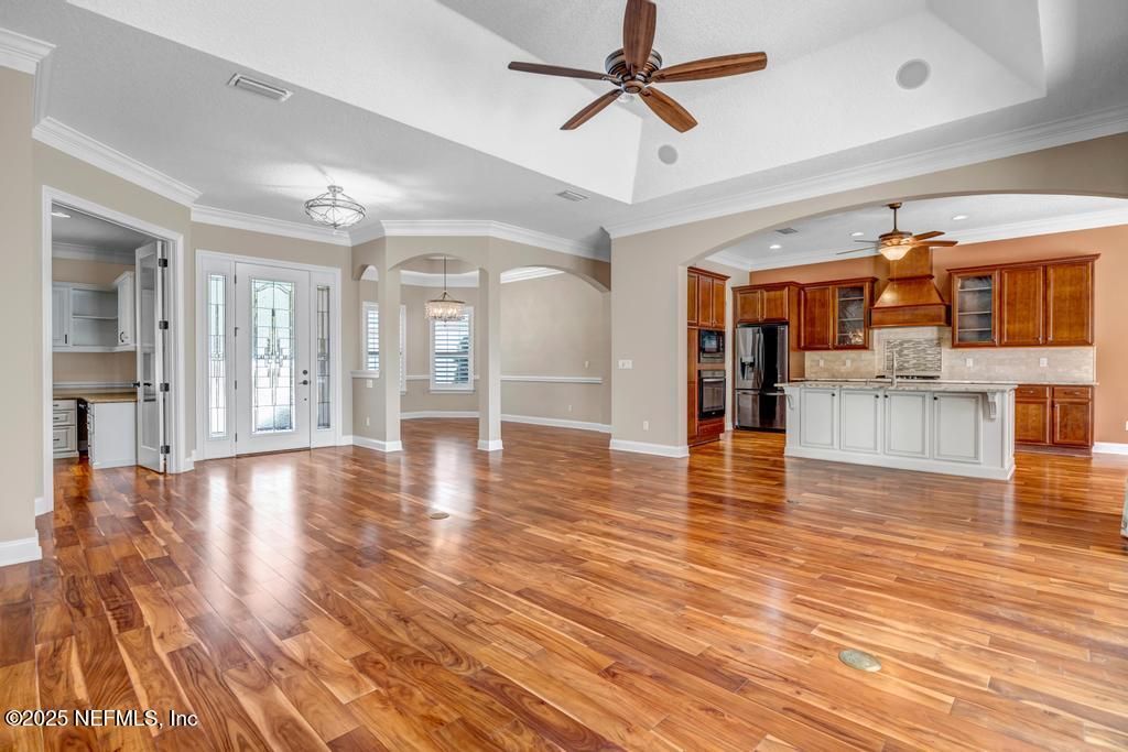 Empty room, Interior, Kitchen, Recessed Lighting, Stainless Steel Appliances, Wood Texture Flooring