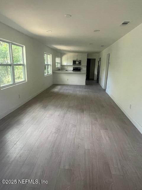 Empty room, Interior, Kitchen, Recessed Lighting, Stainless Steel Appliances, Wood Texture Flooring