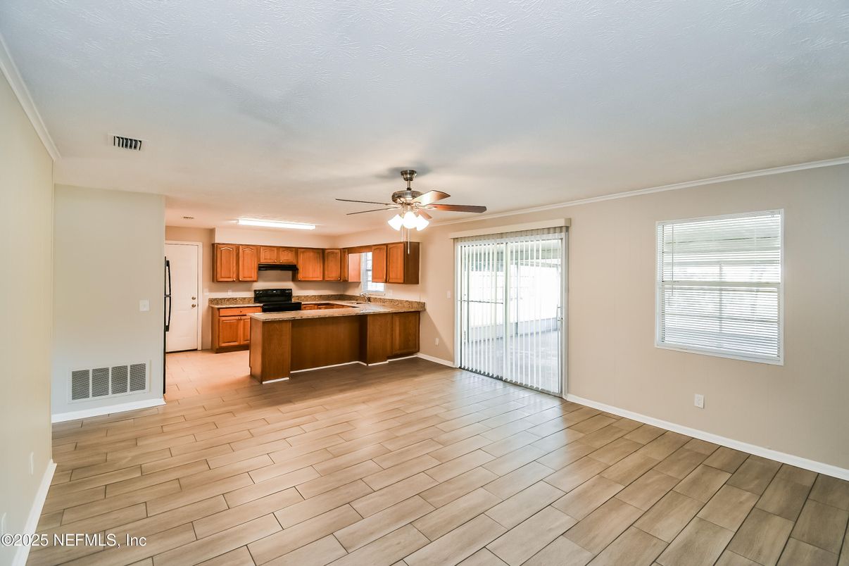 Empty room, Interior, Kitchen, Recessed Lighting, Stainless Steel Appliances, Wood Texture Flooring