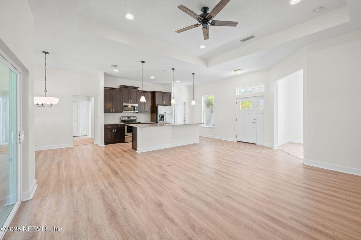 Chandelier, Empty room, Interior, Kitchen, Pendant Lights, Recessed Lighting, Stainless Steel Appliances, Wood Texture Flooring