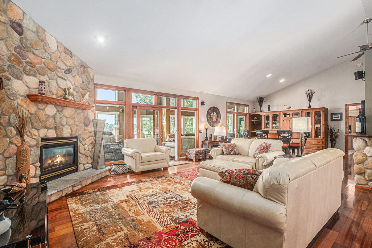 Dining room, Fireplace, Interior, Living room, Recessed Lighting, Stone Walls, Wood Texture Flooring