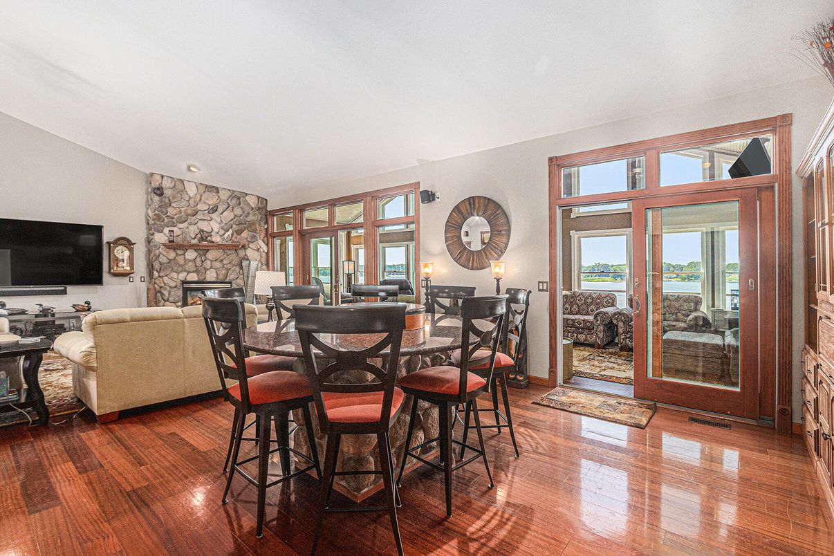 Dining room, Fireplace, Interior, Living room, Recessed Lighting, Stone Walls, Wood Texture Flooring
