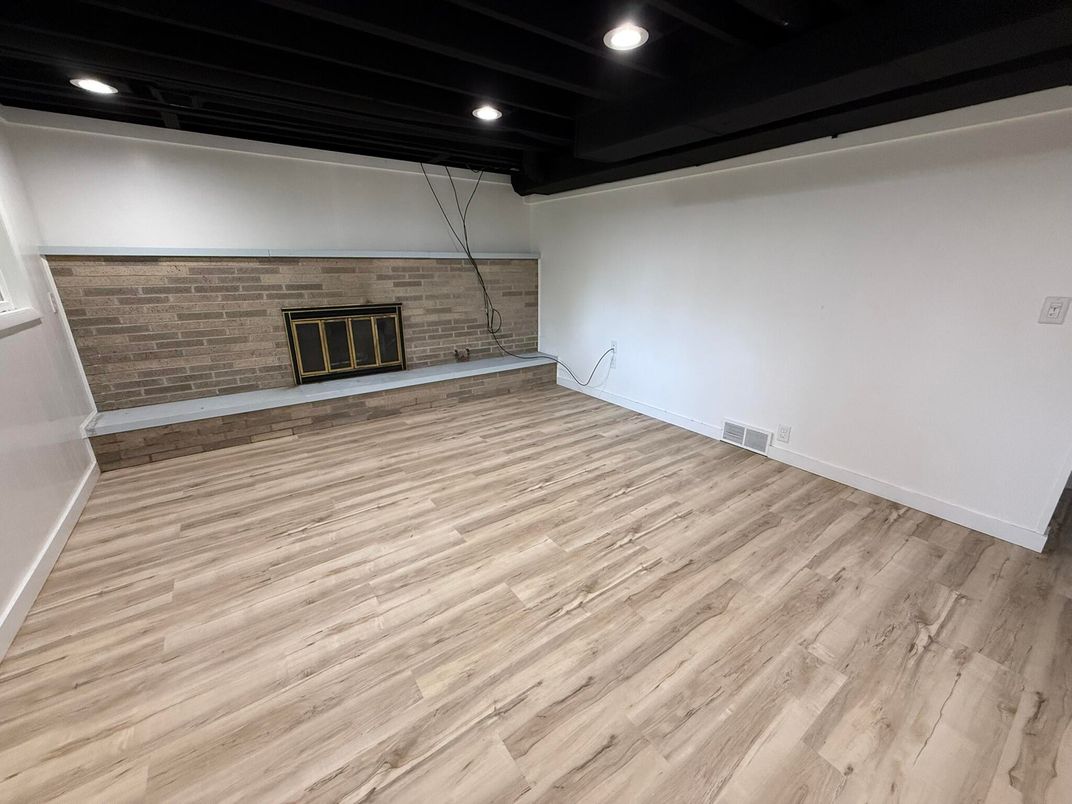 Empty room, Fireplace, Interior, Recessed Lighting, Stone Walls, Wood Texture Flooring
