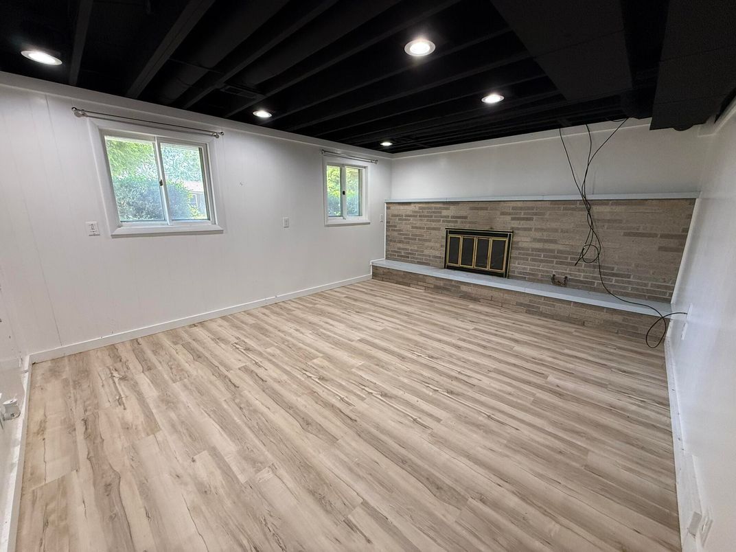 Empty room, Fireplace, Interior, Recessed Lighting, Stone Walls, Wood Texture Flooring