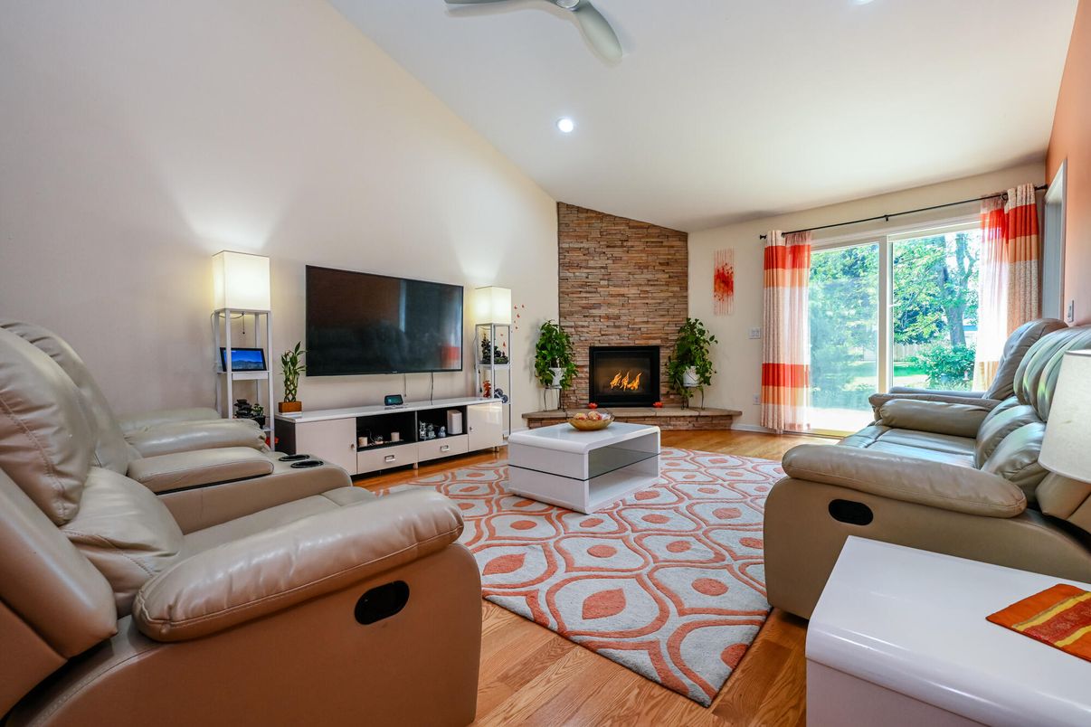 Fireplace, Interior, Living room, Recessed Lighting, Stone Walls, Wood Texture Flooring