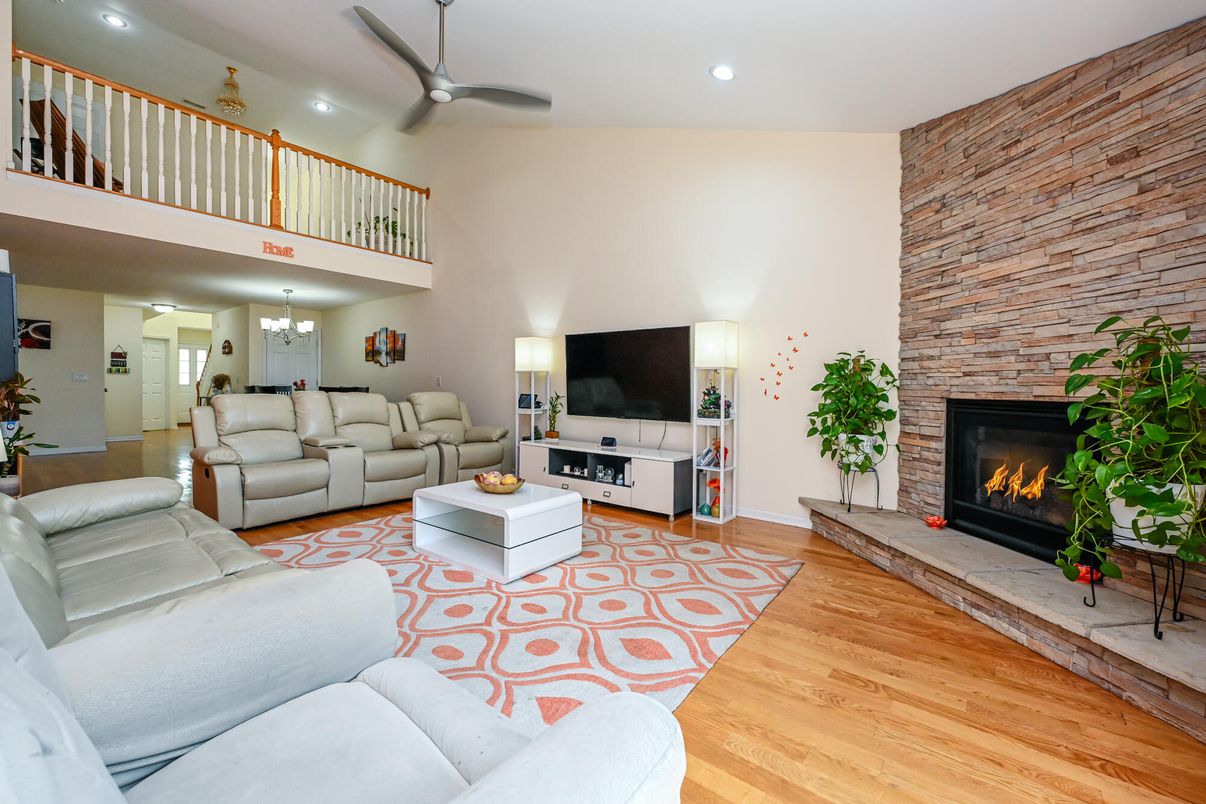 Fireplace, Interior, Living room, Recessed Lighting, Stone Walls, Wood Texture Flooring