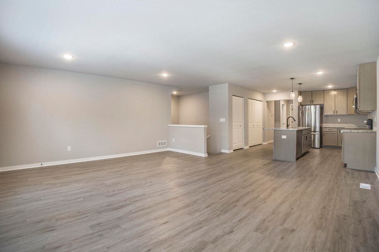 Empty room, Interior, Kitchen, Pendant Lights, Recessed Lighting, Stainless Steel Appliances, Wood Texture Flooring