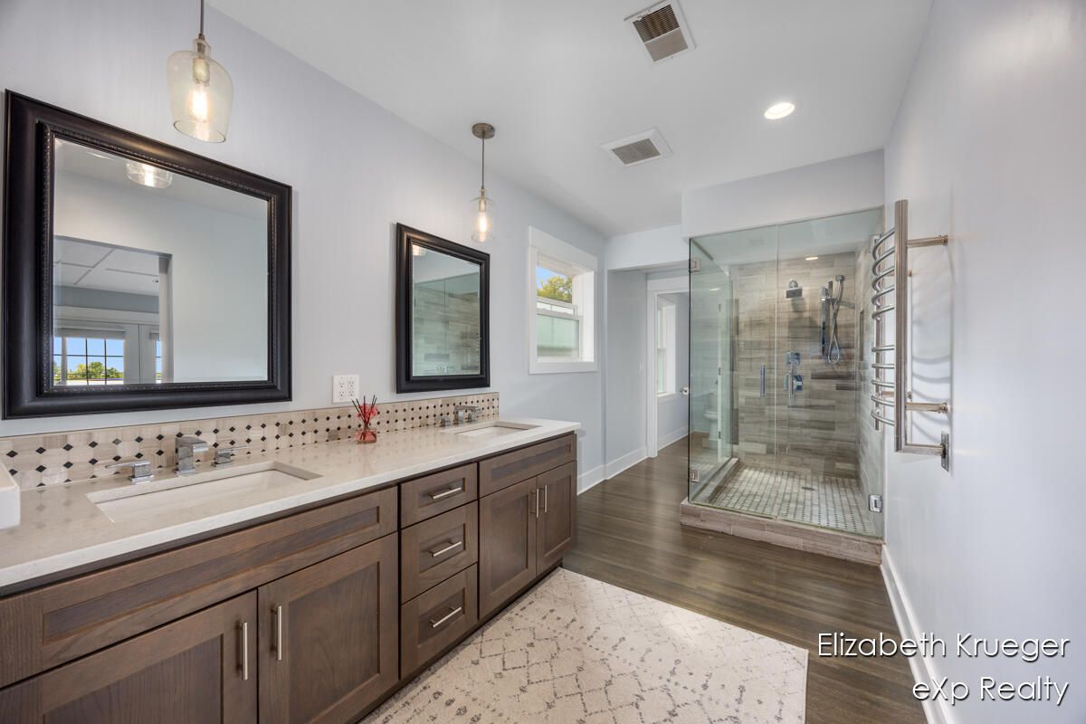 Bathroom, Dual Sink Vanities, Glass Shower, Interior, Pendant Lights, Recessed Lighting, Wood Texture Flooring