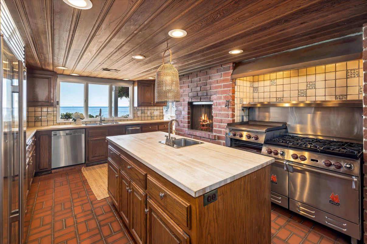 Fireplace, Interior, Kitchen, Pendant Lights, Recessed Lighting, Stainless Steel Appliances, Stone Walls, Water, Wooden Ceilings