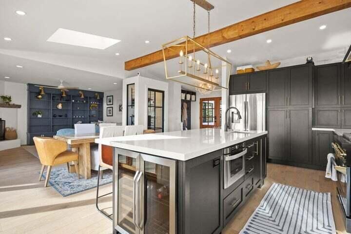 Chandelier, Dining room, Interior, Kitchen, Living room, Pendant Lights, Recessed Lighting, Stainless Steel Appliances, Wooden Beams, Wood Texture Flooring