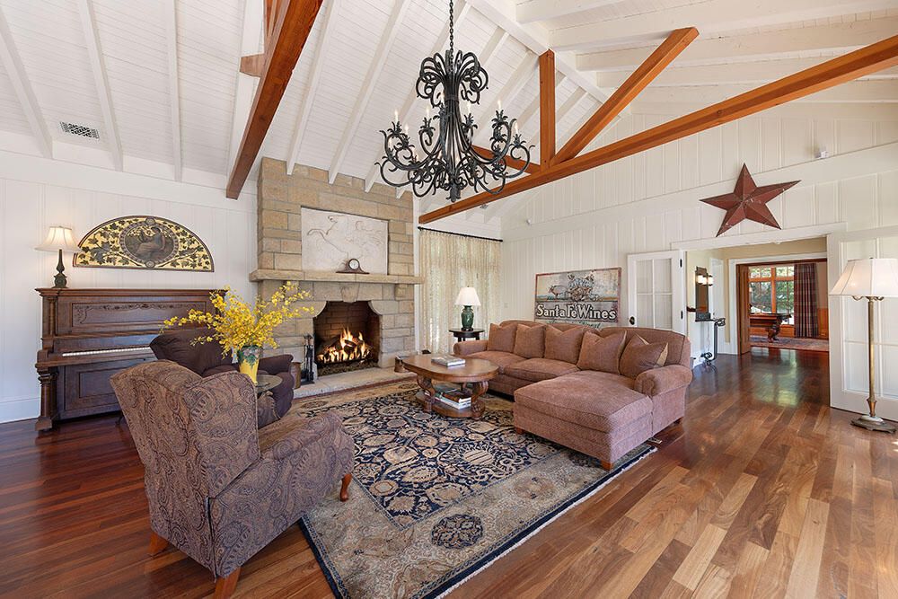 Chandelier, Fireplace, Interior, Living room, Piano, Stone Walls, Wooden Beams, Wood Texture Flooring