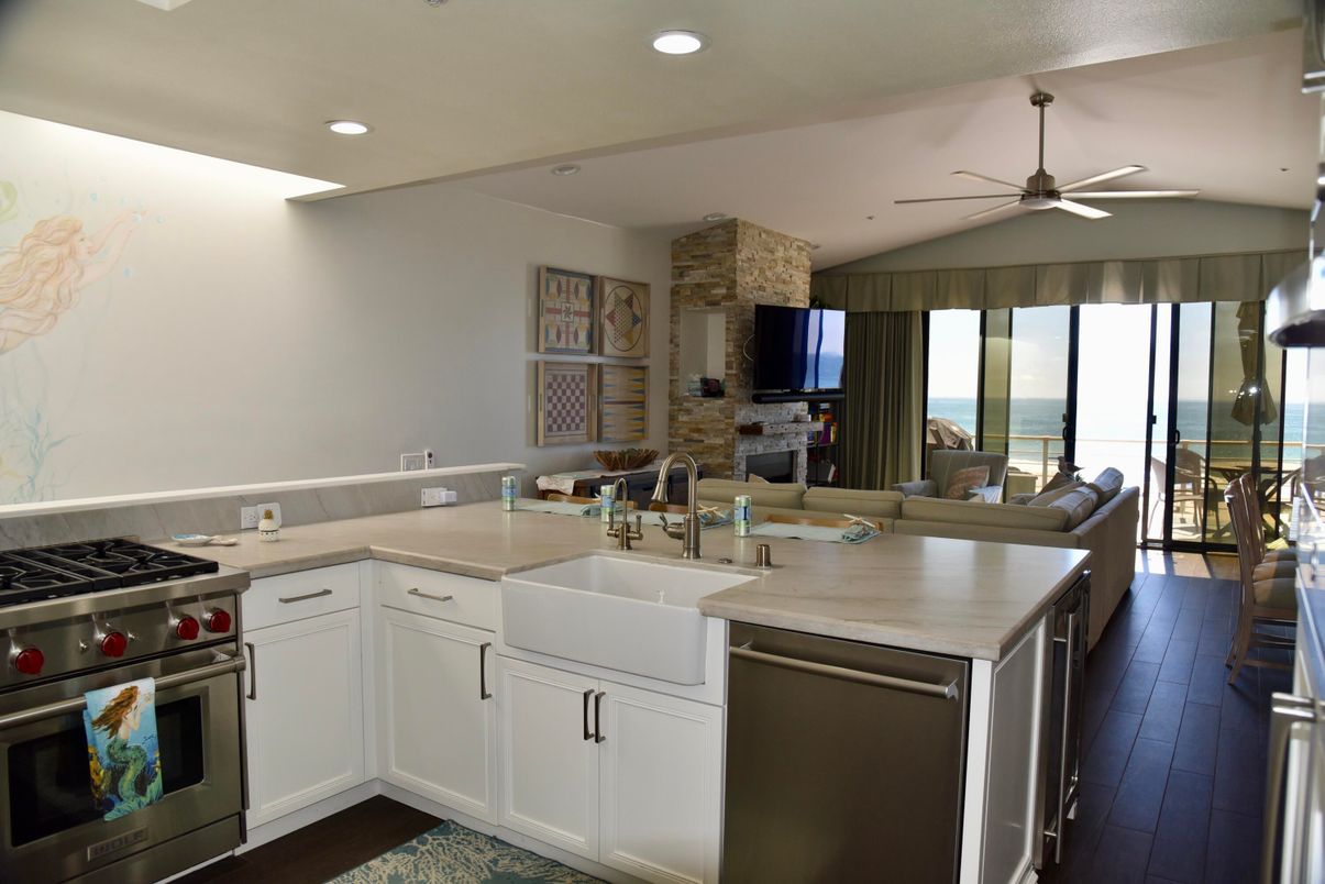 Fireplace, Interior, Kitchen, Living room, Recessed Lighting, Stainless Steel Appliances, Stone Walls, Water, Wood Texture Flooring