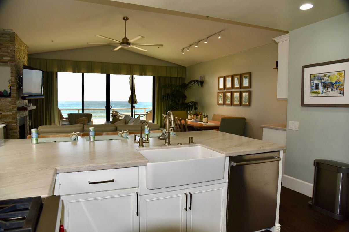 Dining room, Fireplace, Interior, Kitchen, Recessed Lighting, Stone Walls, Water, Wood Texture Flooring