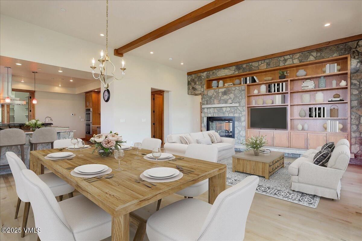 Chandelier, Dining room, Fireplace, Interior, Living room, Pendant Lights, Recessed Lighting, Stone Walls, Wooden Beams, Wood Texture Flooring