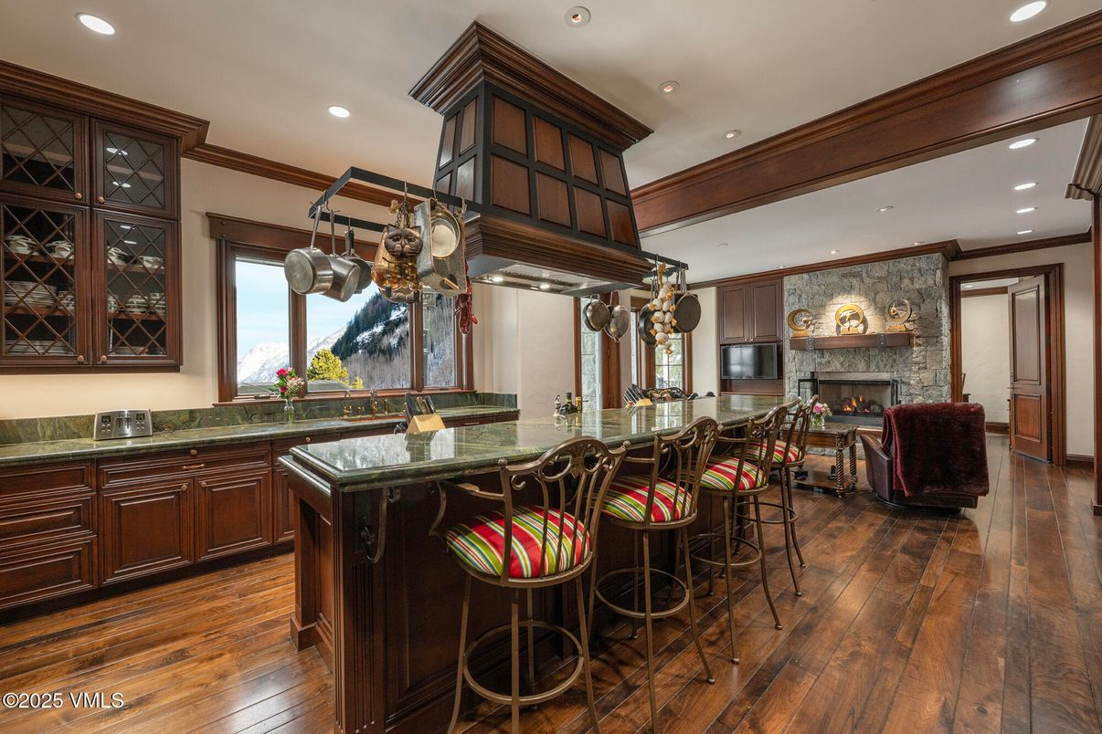 Dining room, Fireplace, Interior, Kitchen, Recessed Lighting, Stone Walls, Wood Texture Flooring