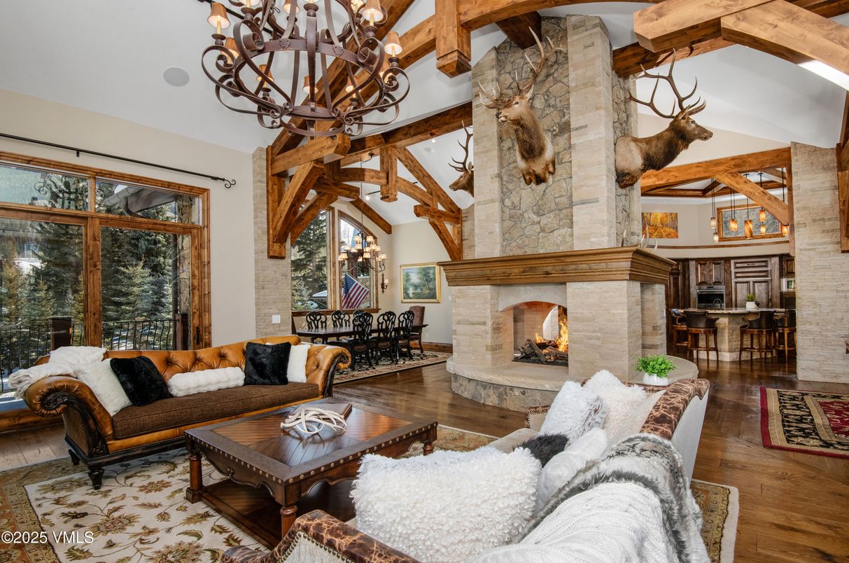 Chandelier, Dining room, Fireplace, Interior, Living room, Stone Walls, Wooden Beams, Wood Texture Flooring