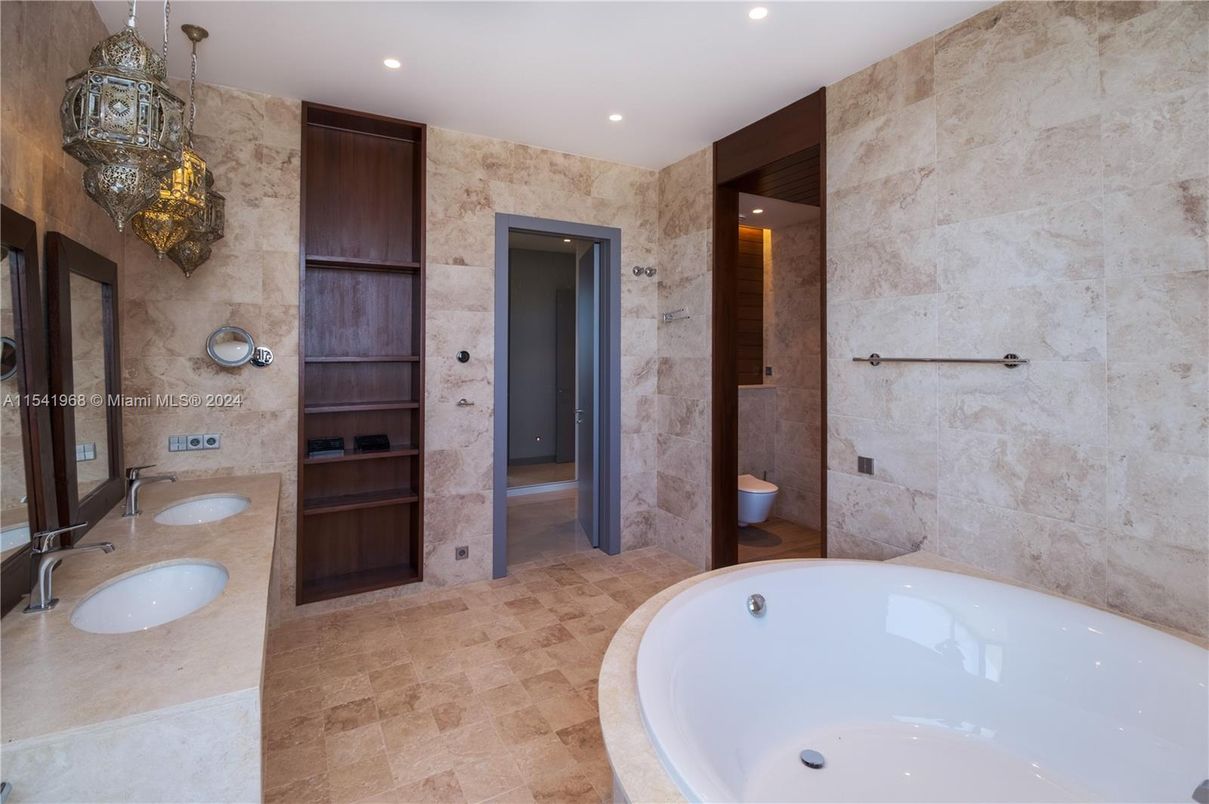 Bathroom, Dual Sink Vanities, Interior, Pendant Lights, Recessed Lighting, Stone Walls