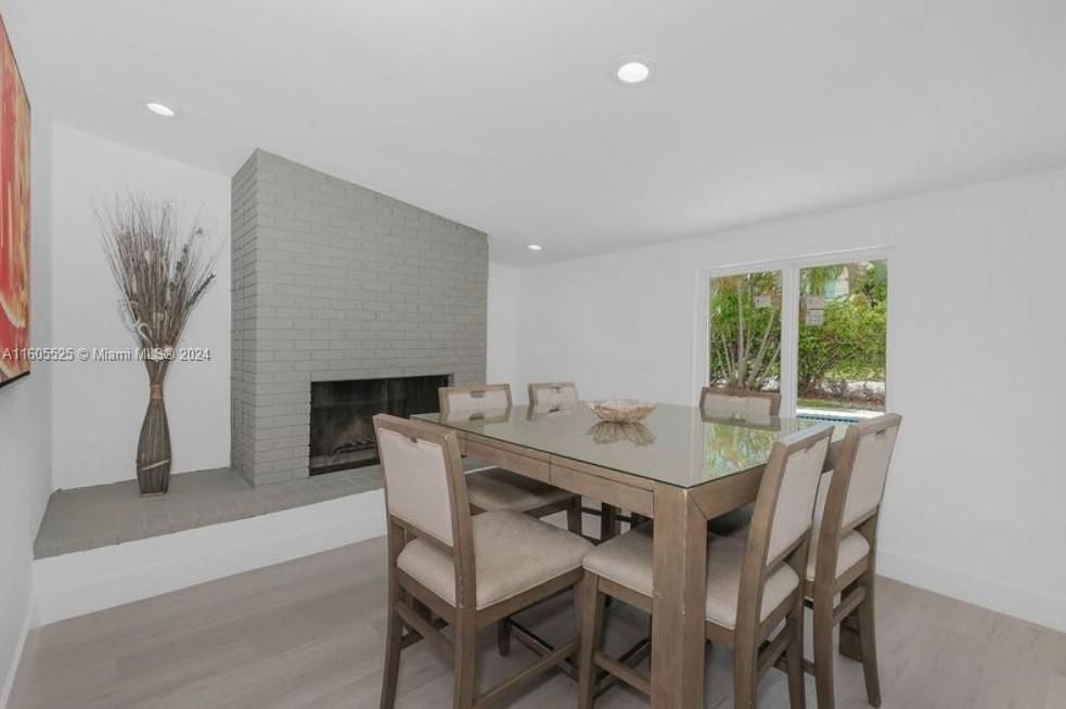 Dining room, Fireplace, Interior, Recessed Lighting, Stone Walls, Wood Texture Flooring