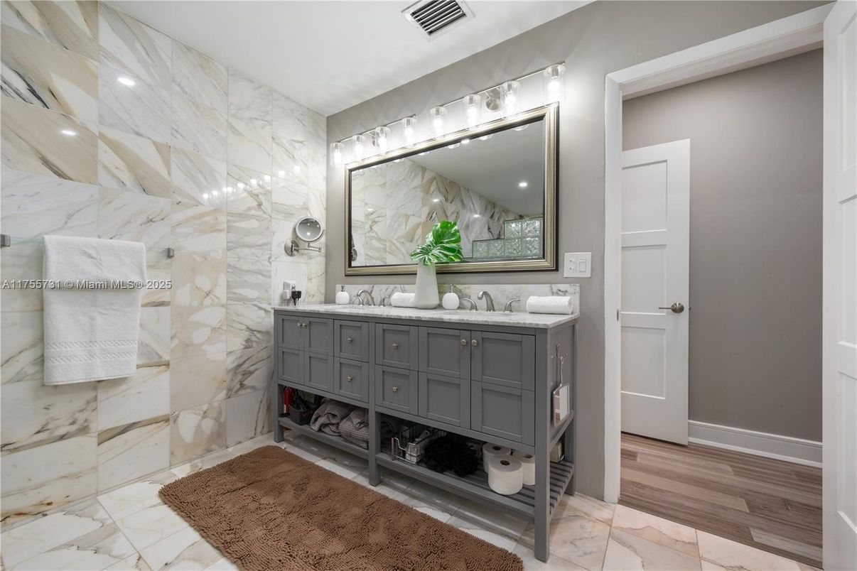 Bathroom, Dual Sink Vanities, Interior, Marble, Marble Walls, Recessed Lighting, Wood Texture Flooring