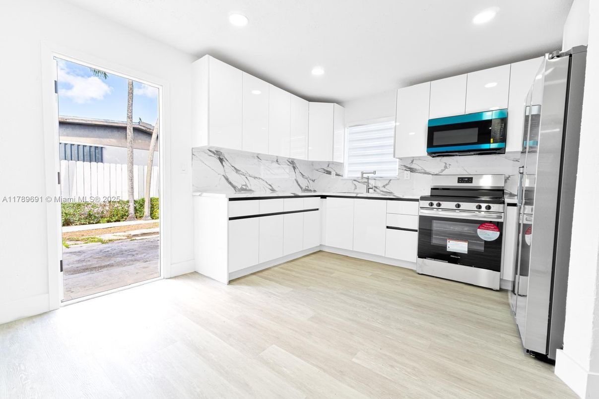 Interior, Kitchen, Marble Walls, Recessed Lighting, Stainless Steel Appliances, Wood Texture Flooring