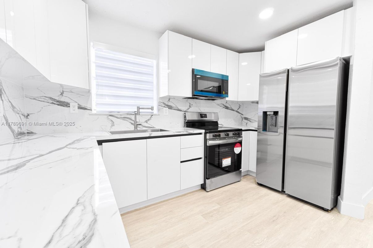 Interior, Kitchen, Marble Walls, Recessed Lighting, Stainless Steel Appliances, Wood Texture Flooring