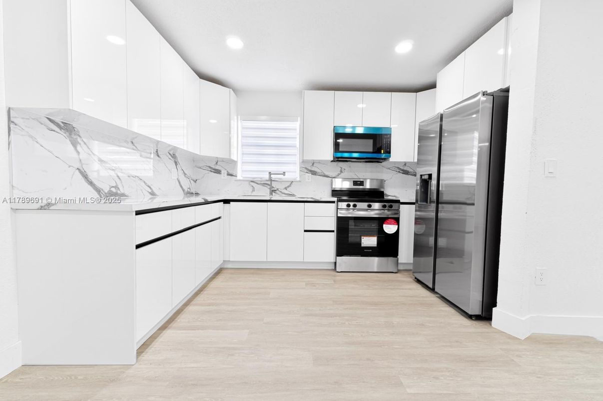 Interior, Kitchen, Marble Walls, Recessed Lighting, Stainless Steel Appliances, Wood Texture Flooring