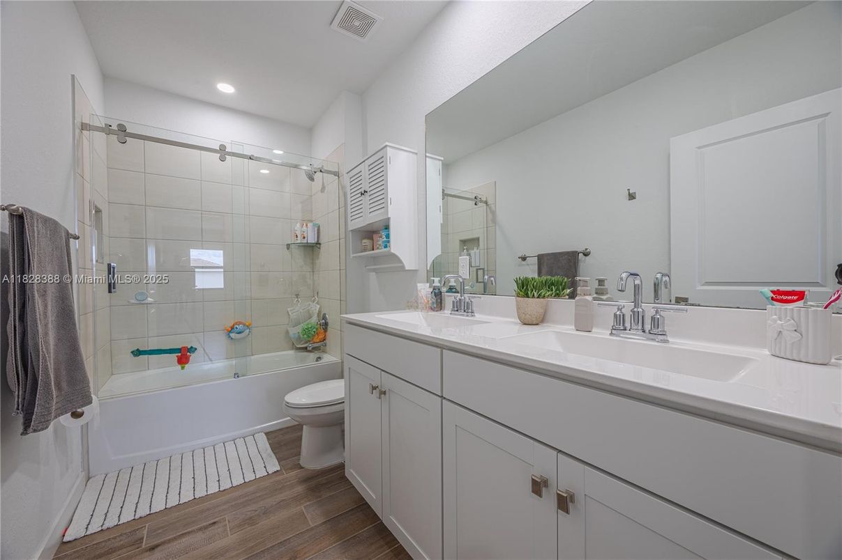 Bathroom, Dual Sink Vanities, Glass Shower, Interior, Recessed Lighting, Wood Texture Flooring