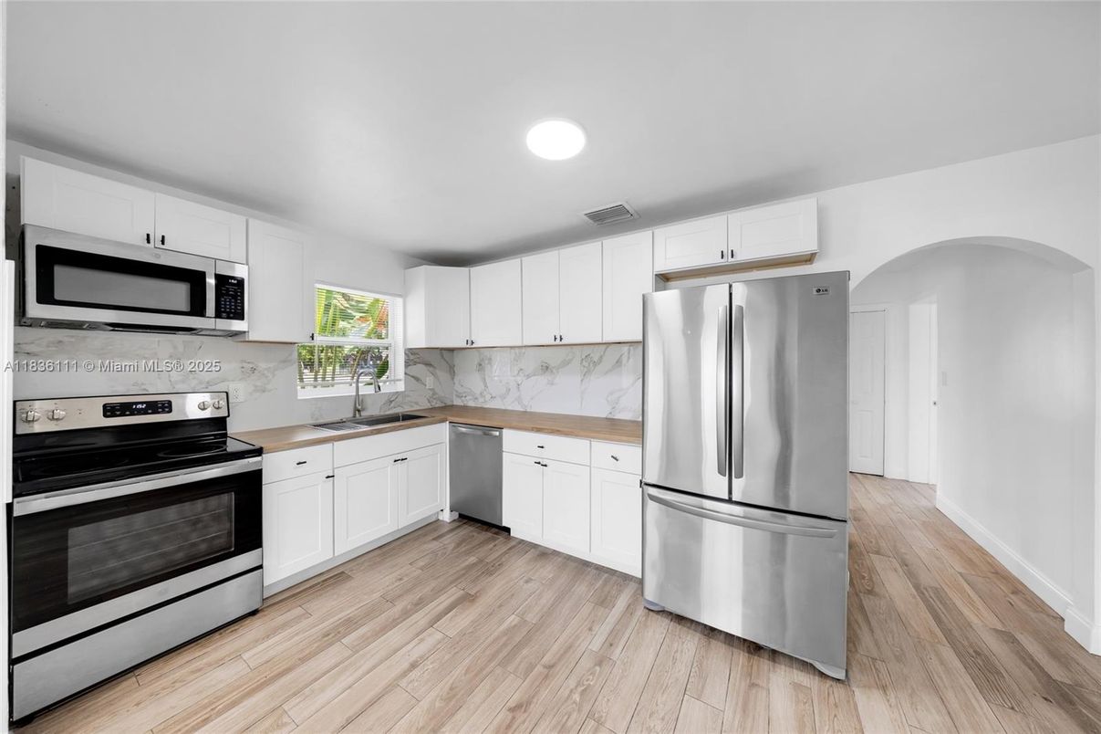 Interior, Kitchen, Marble Walls, Recessed Lighting, Stainless Steel Appliances, Wood Texture Flooring