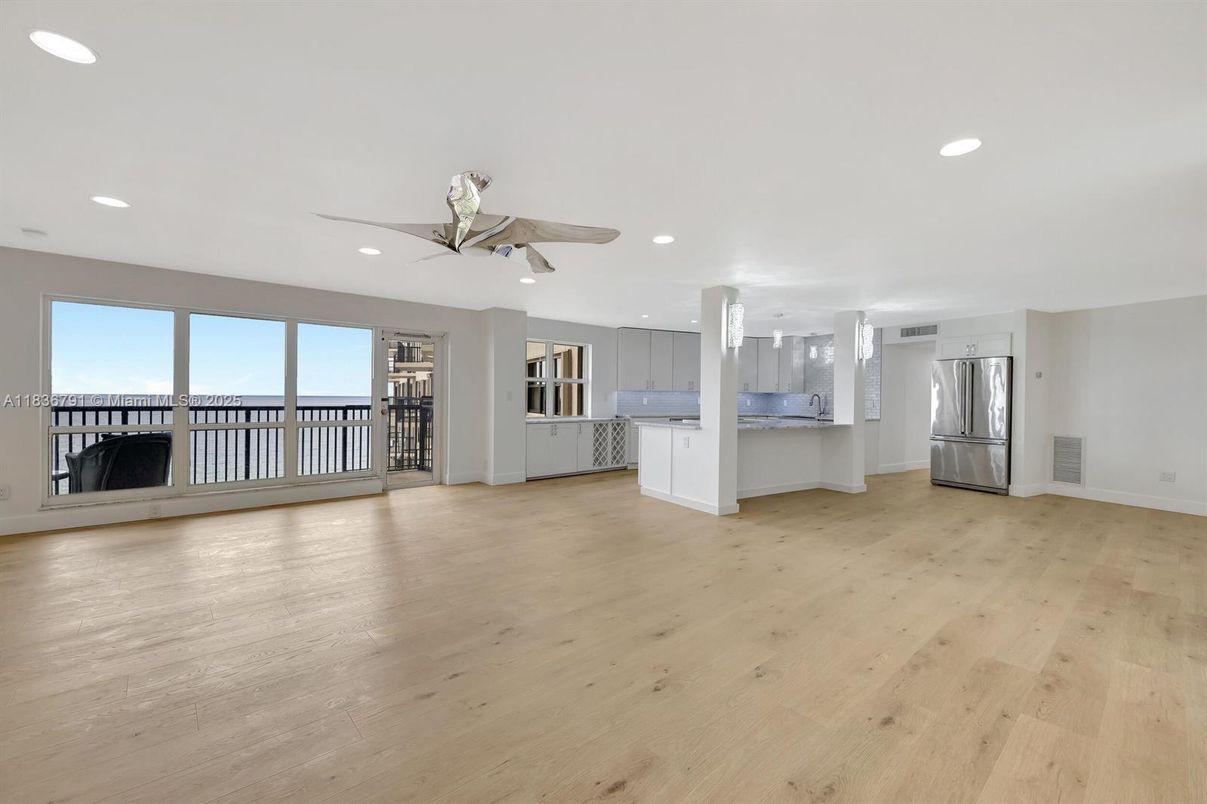 Empty room, Interior, Kitchen, Recessed Lighting, Stainless Steel Appliances, Wood Texture Flooring