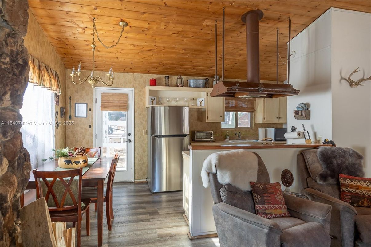Chandelier, Dining room, Interior, Kitchen, Living room, Pendant Lights, Stainless Steel Appliances, Wooden Ceilings, Wood Texture Flooring