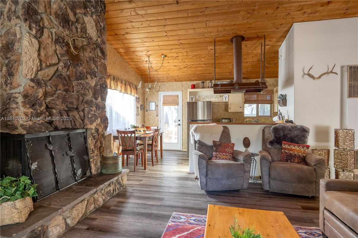 Dining room, Fireplace, Interior, Kitchen, Living room, Pendant Lights, Stainless Steel Appliances, Stone Walls, Wooden Ceilings, Wood Texture Flooring