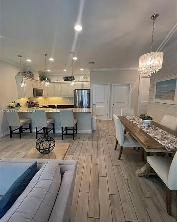 Chandelier, Dining room, Interior, Kitchen, Pendant Lights, Recessed Lighting, Stainless Steel Appliances, Wood Texture Flooring