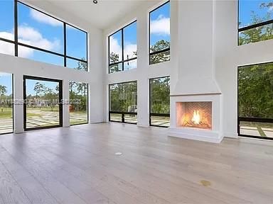 Empty room, Fireplace, Interior, Recessed Lighting, Sun Room, Wood Texture Flooring