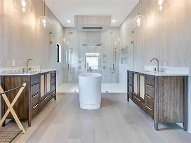 Bathroom, Dual Sink Vanities, Free Standing Baths, Glass Shower, Interior, Pendant Lights, Recessed Lighting, Wood Texture Flooring