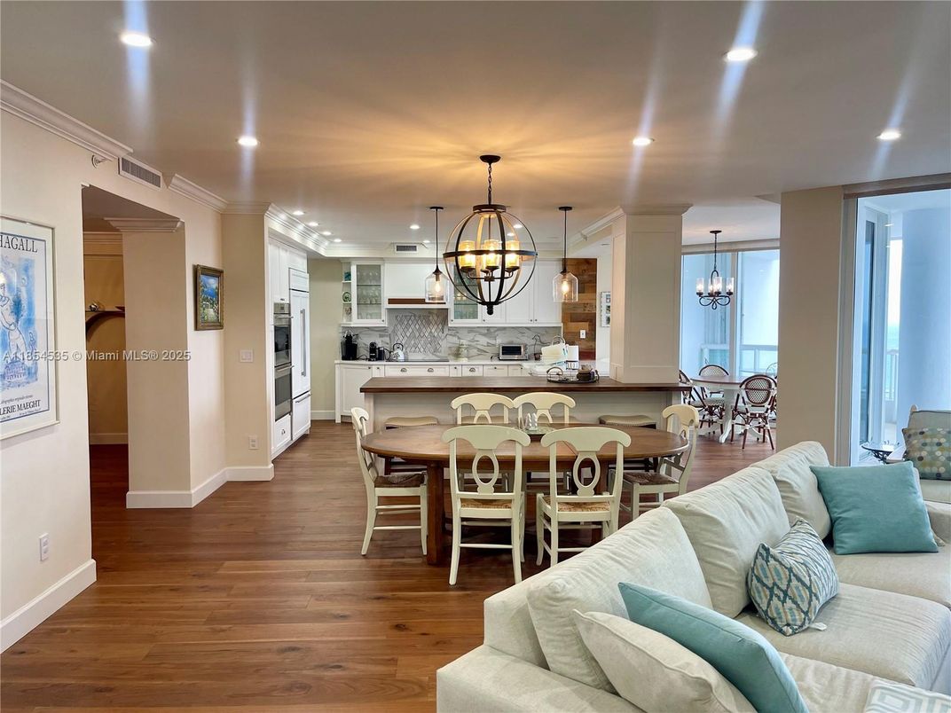 Chandelier, Dining room, Interior, Kitchen, Living room, Pendant Lights, Recessed Lighting, Stainless Steel Appliances, Wood Texture Flooring