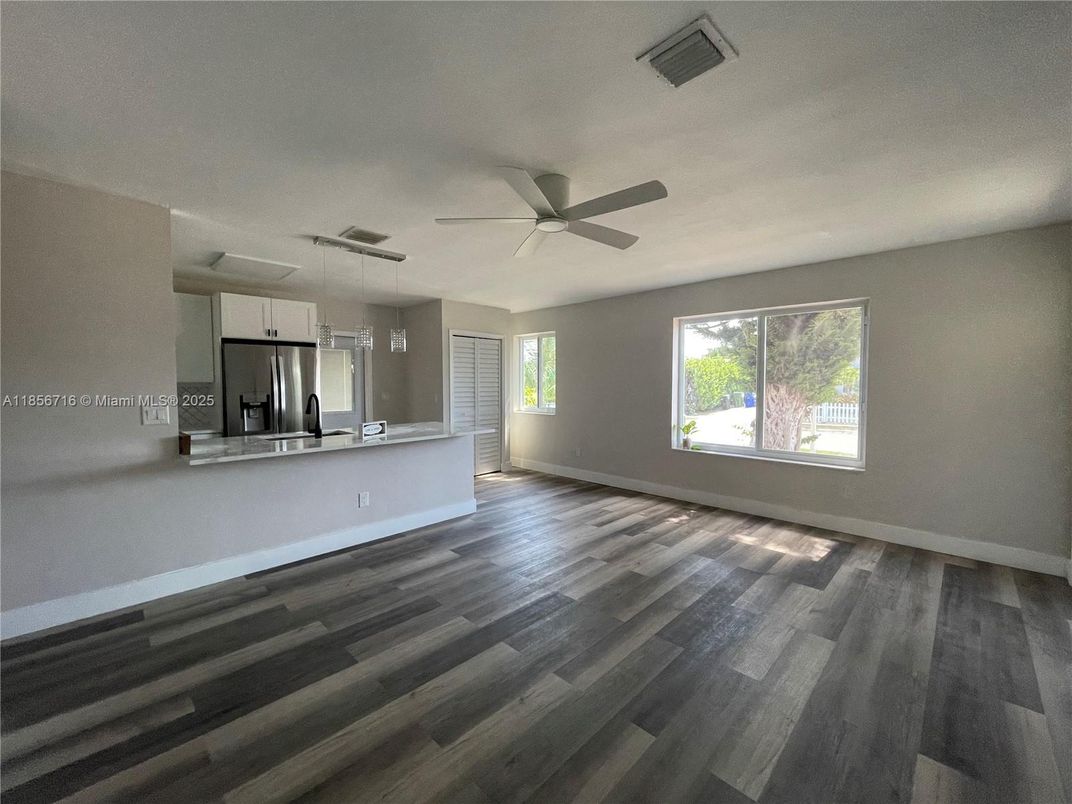 Empty room, Interior, Kitchen, Pendant Lights, Stainless Steel Appliances, Wood Texture Flooring