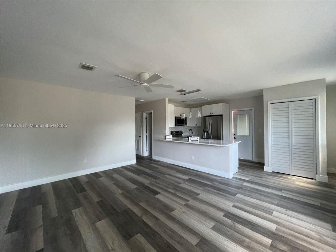 Empty room, Interior, Kitchen, Stainless Steel Appliances, Wood Texture Flooring