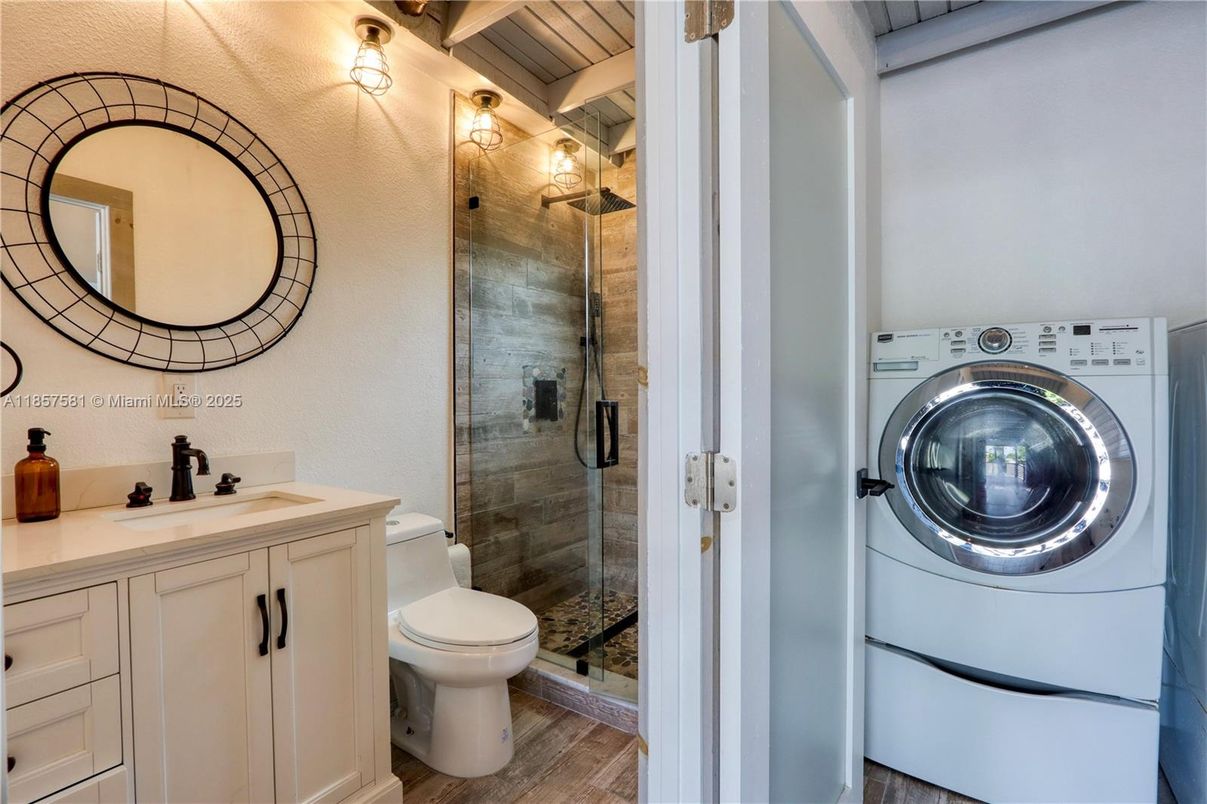 Bathroom, Glass Shower, Interior, Washer, Wood Texture Flooring