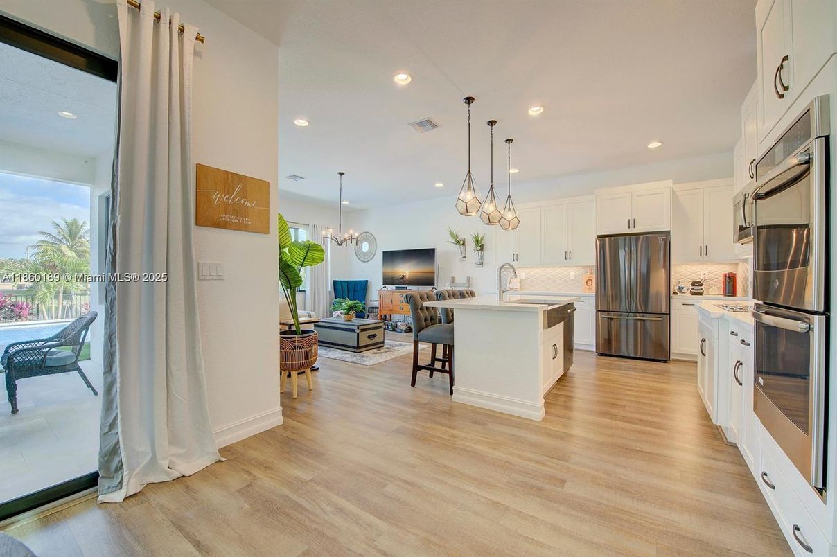 Dining room, Interior, Kitchen, Pendant Lights, Recessed Lighting, Stainless Steel Appliances, Wood Texture Flooring