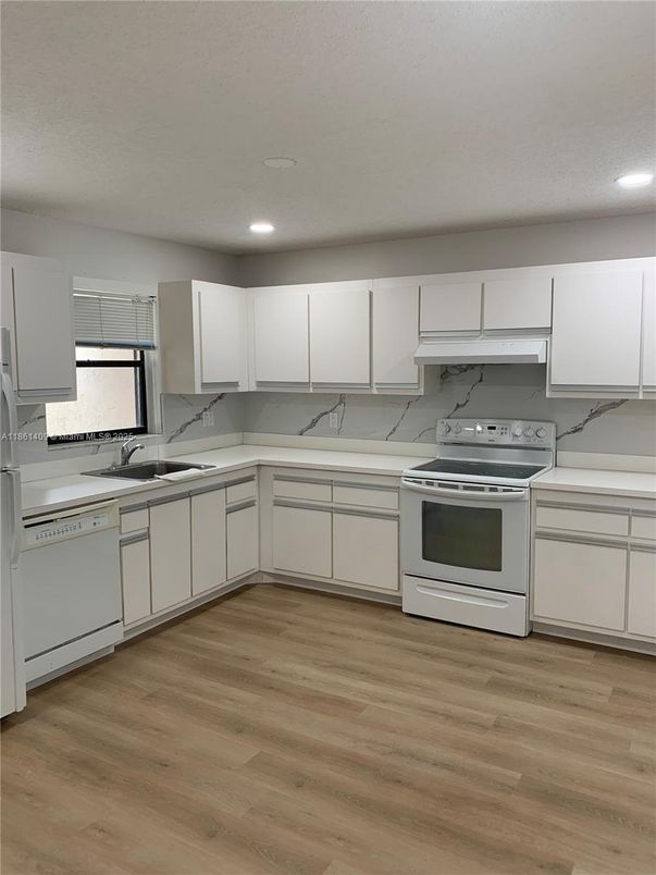 Interior, Kitchen, Marble Walls, Recessed Lighting, Stainless Steel Appliances, Wood Texture Flooring