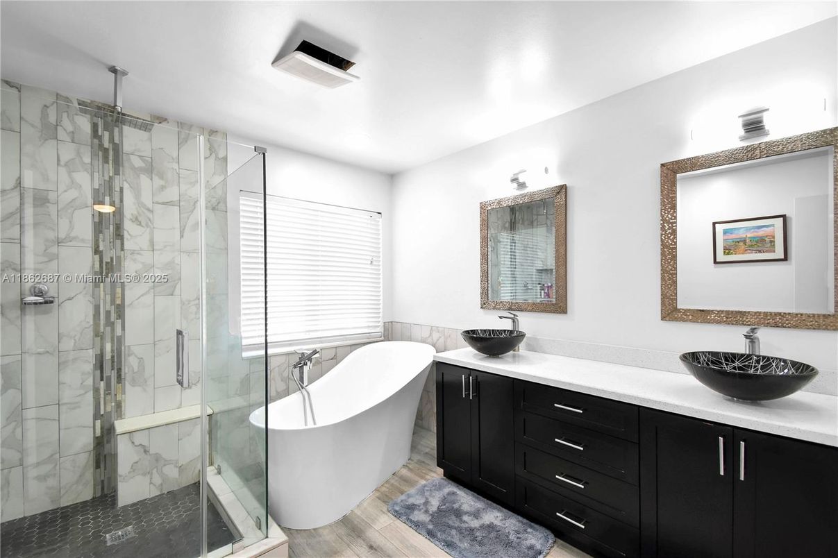 Bathroom, Dual Sink Vanities, Free Standing Baths, Glass Shower, Interior, Marble Walls, Wood Texture Flooring