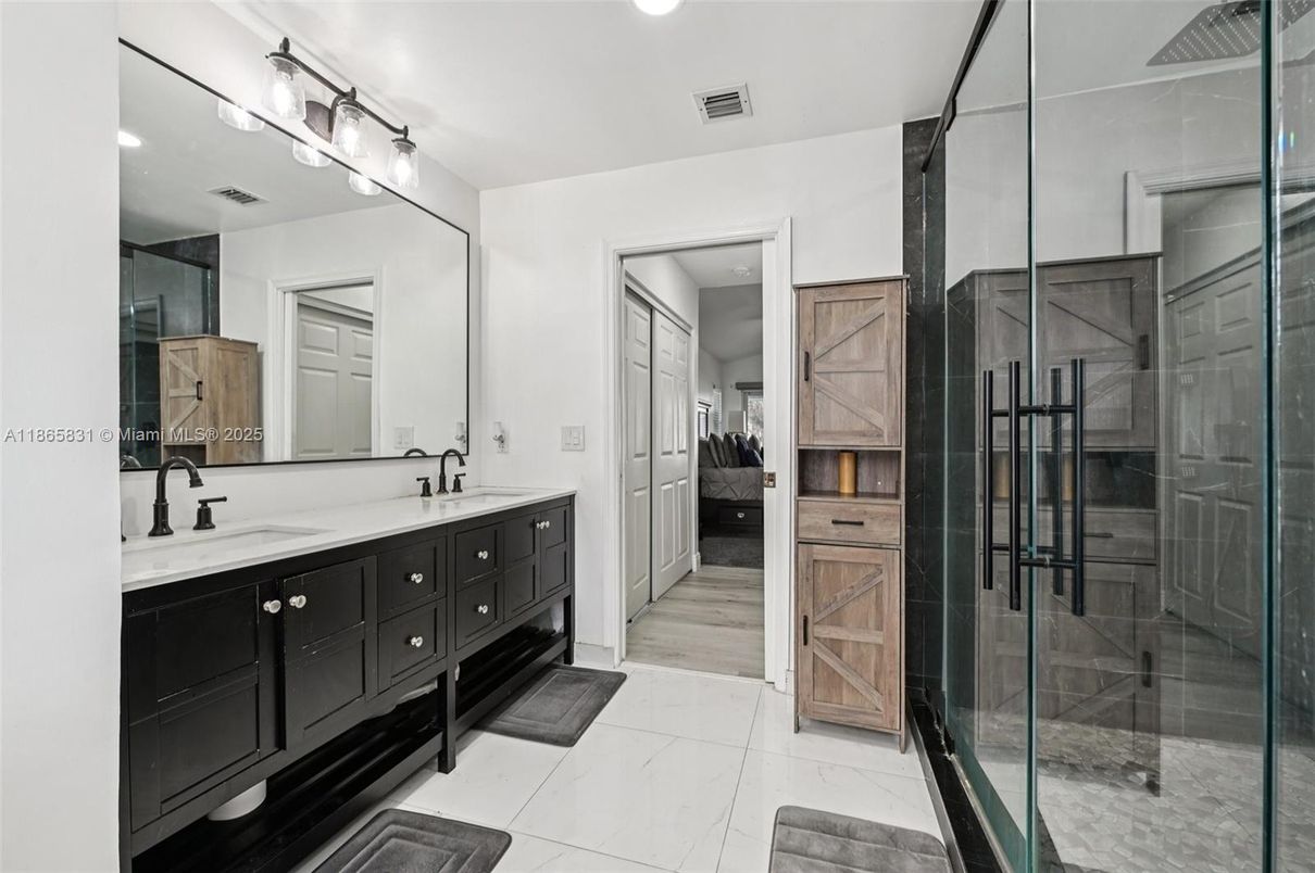 Bathroom, Dual Sink Vanities, Glass Shower, Interior, Marble, Recessed Lighting, Wood Texture Flooring