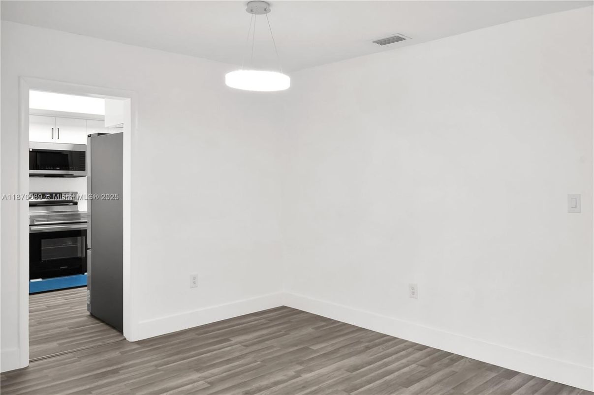 Empty room, Interior, Kitchen, Pendant Lights, Stainless Steel Appliances, Wood Texture Flooring