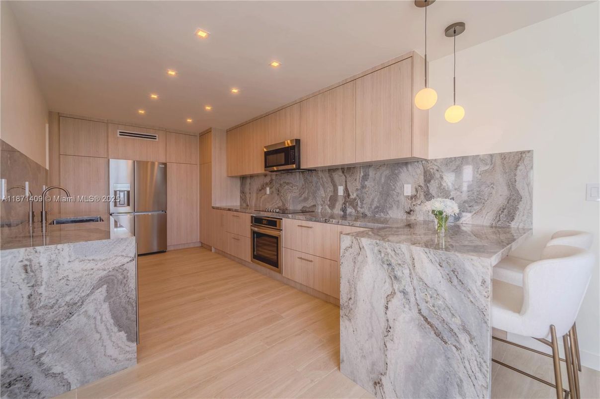 Interior, Kitchen, Marble Walls, Pendant Lights, Recessed Lighting, Stainless Steel Appliances, Wood Texture Flooring