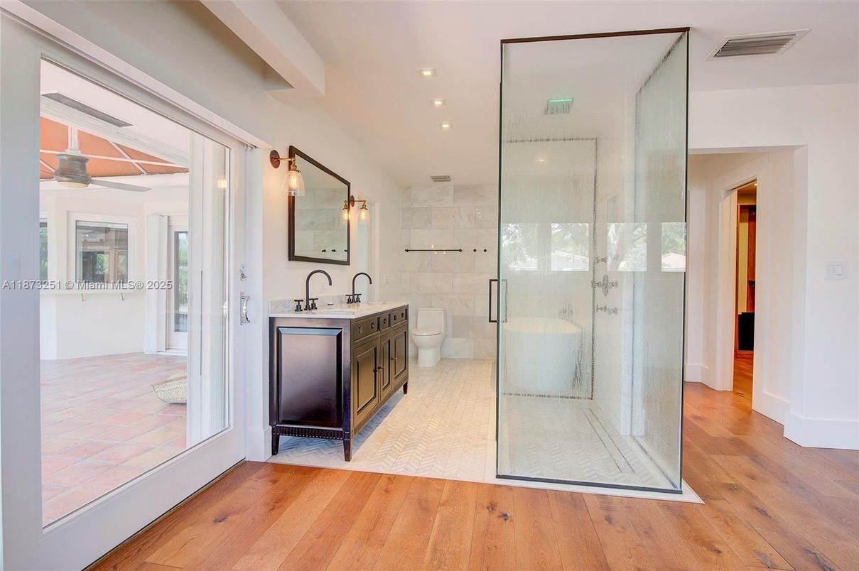 Bathroom, Dual Sink Vanities, Free Standing Baths, Glass Shower, Interior, Recessed Lighting, Wood Texture Flooring